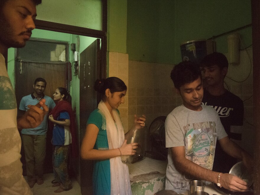 Saumil and Zarina Shah (background) help do chores with other newlywed couples at a Love Commandos safe house in New Delhi.