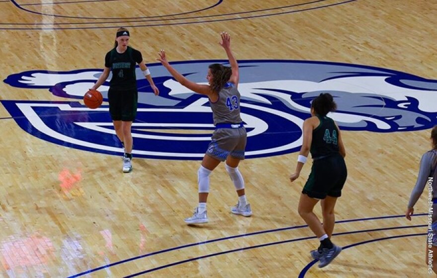 Action shot of Kylie Coleman and Mia Stillman vs Drake basketball