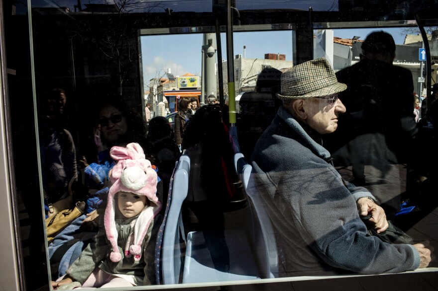 Riding on the rail line, Israeli children and adults alike are dressed for the Jewish holiday of Purim.