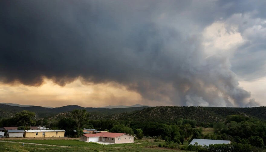 Smoke from the Frijoles Fire drifts over Cordova, located in Rio Arriba County, on Monday afternoon. Residents in one area within the village of Cundiyó were directed to leave their homes as the fire surpassed 4,000 acres.