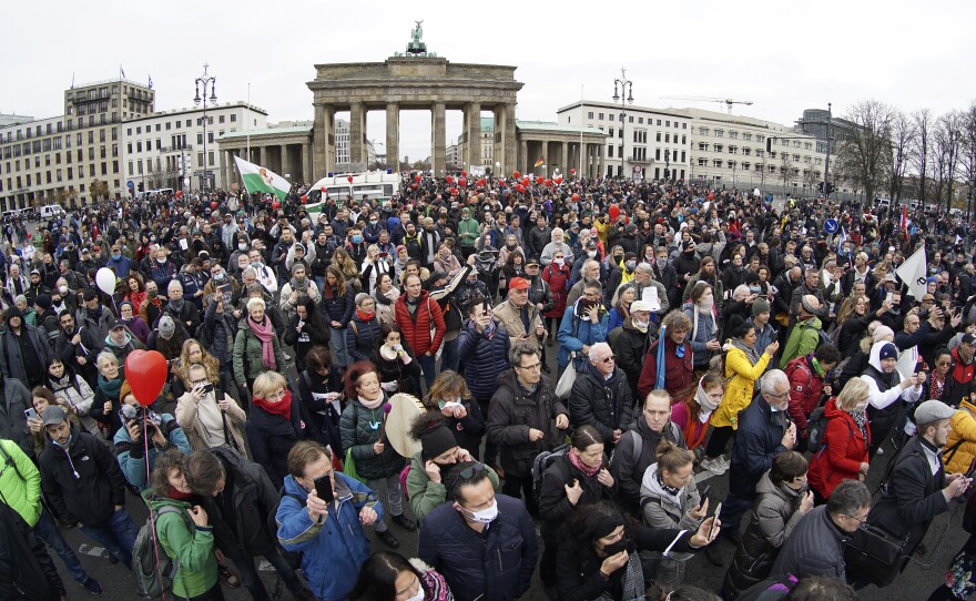 Crowds gather Wednesday in front of the Brandenburg Gate in Berlin to protest coronavirus restrictions in Germany.
