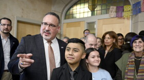 Secretary of Education Miguel Cardona with students Joshua Santiago and Melinda Martinez at Fair Haven School in New Haven. Cardona spoke along with other local and state officials over a $2.5 million dollar federal grant to support community school initiatives which will last over a five year period in New Haven, Connecticut January 29, 2024.