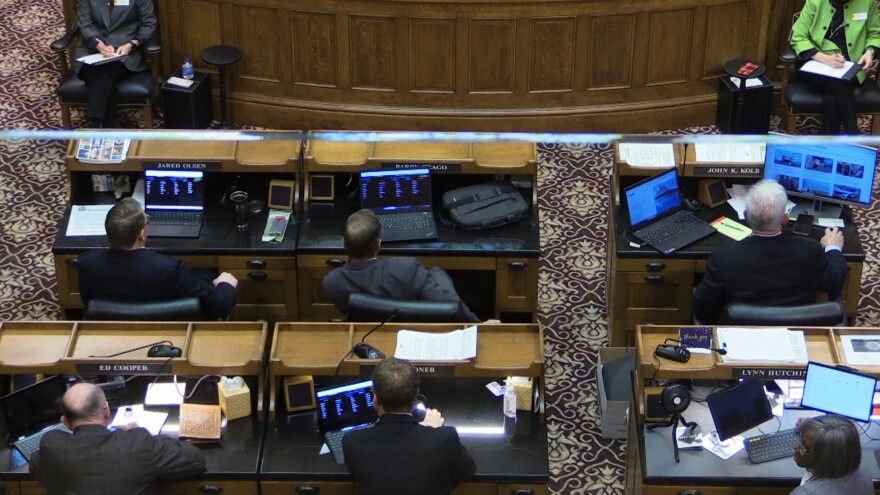 memebers of the senate looking at computers at their desk