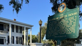 Historic House in Madison, Fla., with debris piled at the curb following Hurricane Idalia