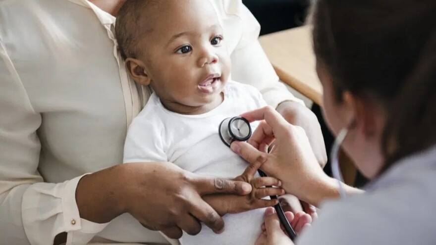 Black Doctor With Child 