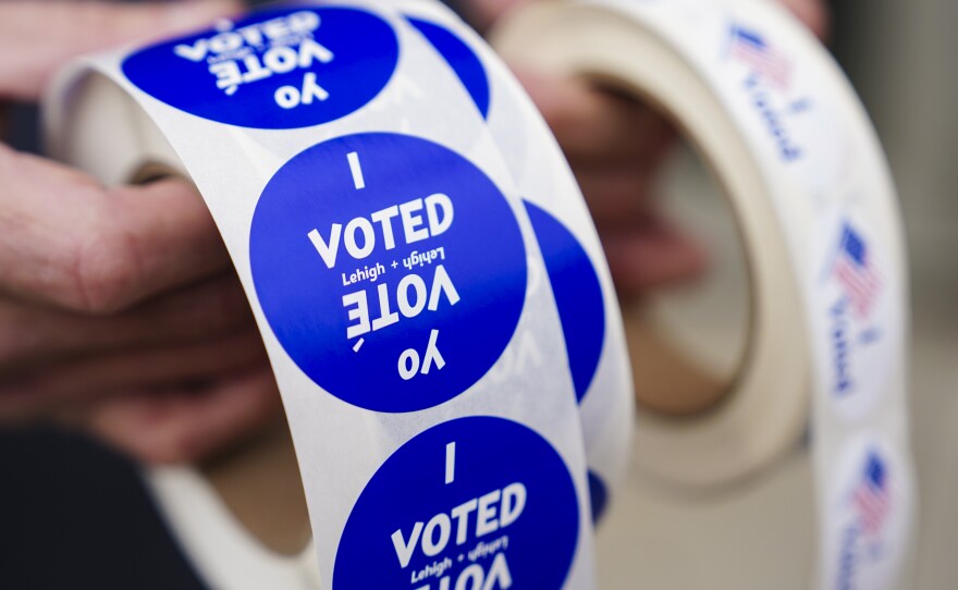 A poll worker holds voting stickers for community members Nov. 7, 2023, at Central Elementary School in Allentown, Lehigh County, Pennsylvania.