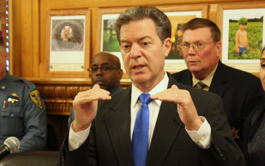Governor Sam Brownback speaking to reporters this month. (Photo by Stephen Koranda)