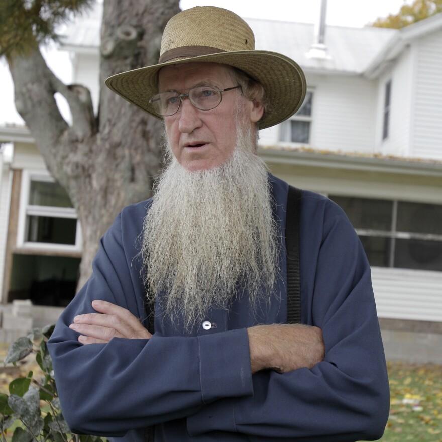 Amish bishop Samuel Mullet stands in front of his home in Bergholz, Ohio. He was found guilty of masterminding a plan to cut off beards and hair of other Amish.