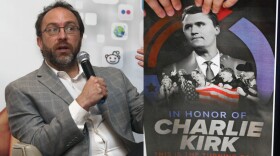 People hold posters of Charlie Kirk during a Turning Point USA rally at Utah State University, as a part of the organization's push to memorialize Kirk, Tuesday, Sept. 30, 2025, in Logan, Utah. (AP Photo/Alex Goodlett)