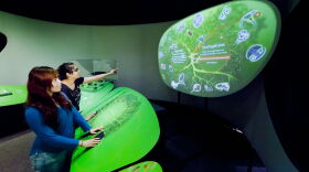 Visitors are pictured exploring the Genome: Unlocking Life's Code exhibit at MOSH.