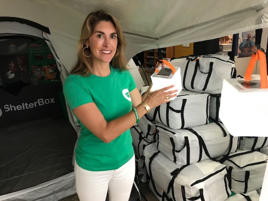 ShelterBox USA President Kerri Murray with one of the solar lamps in the ShelterBox kits.