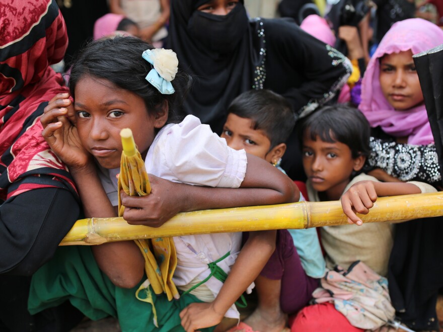 Rohingya children wait for food handouts at Thangkhali refugee camp in Cox's Bazar, Bangladesh, on Thursday.