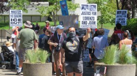 People protesting outside building. 
