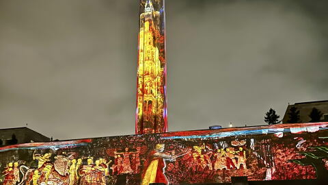 Liberty Memorial lit colorfully with classic-looking characters