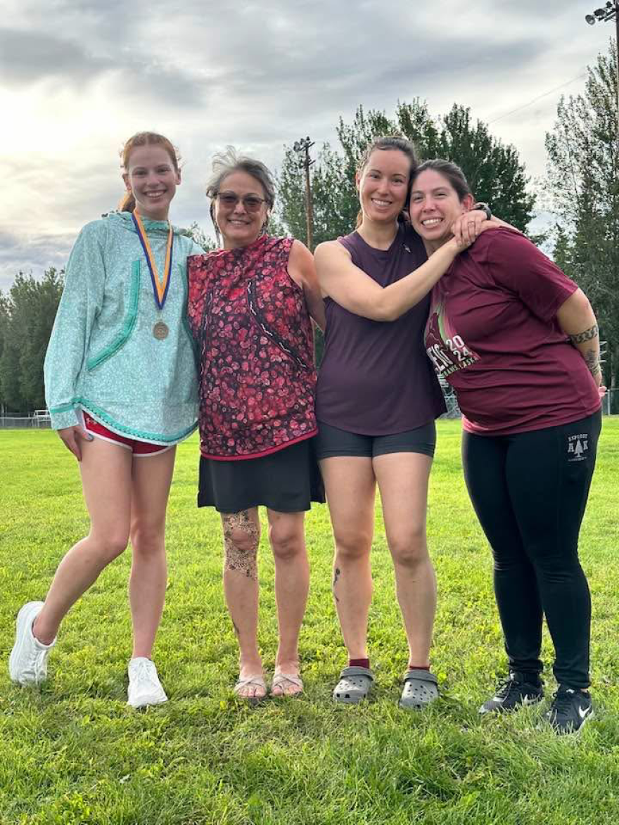 Emily King (left), standing beside Carol Pickett Hull (2nd from left), after setting a new world record for the One-Foot High Kick at the 2024 World Indian Eskimo Olympics. Hull set her record of seven feet in 1989, which stood for 35 years until King surpassed it by one inch. King is a Canadian from Whitehorse in the Yukon Territories.