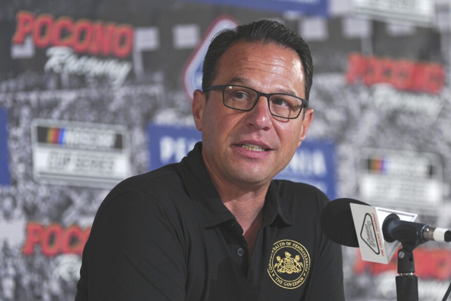 FILE - Pennsylvania Gov. Josh Shapiro talks to the media prior to a NASCAR Cup Series auto race at Pocono Raceway, Sunday, June 22, 2025, in Long Pond, Pa.