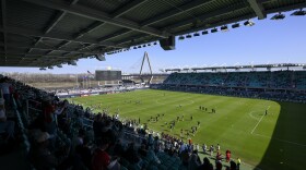 The Christopher S. Bond Bridge over the Missouri River is seen from the new CPKC Stadium as players warm up before the match between the Kansas City Current and the Portland Thorns FC, Saturday, March 16, 2024, in Kansas City, Mo.