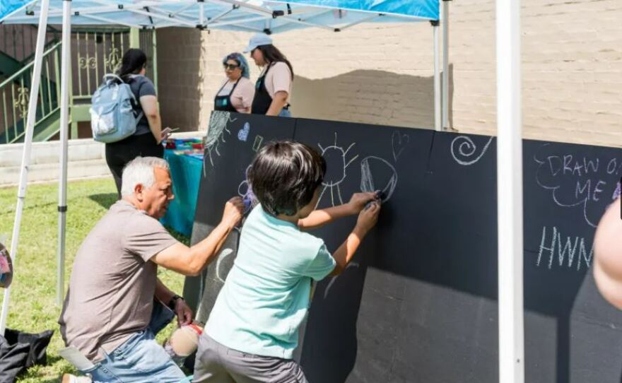 A child draws with chalk at the Amon Carter Museum of American Art’s table on April 30.