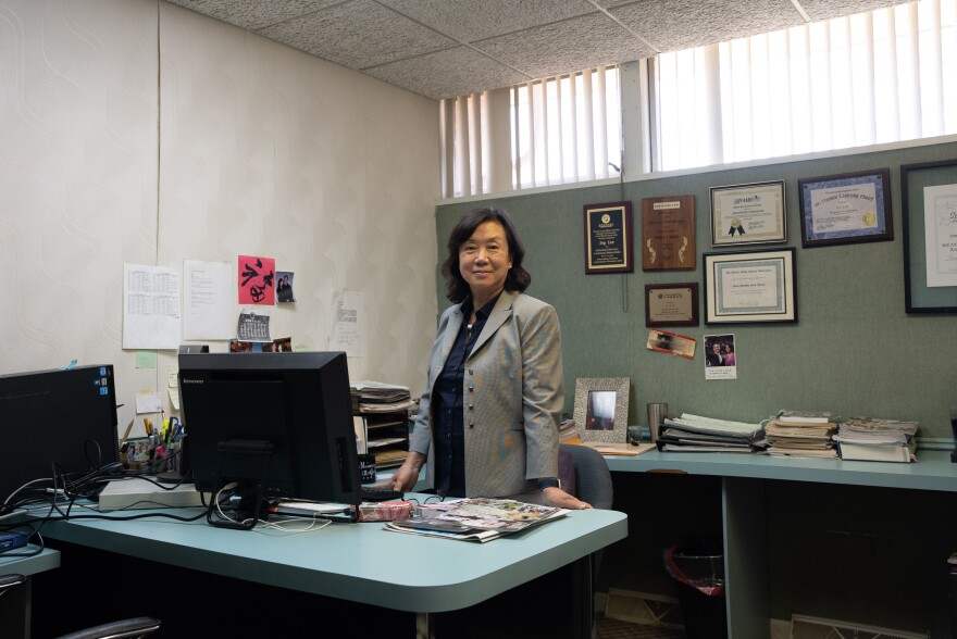 Ivy Lee, founder and editor of the independent Chinese-language magazine <em>Sino Monthly</em>, stands behind her desk at the magazine's N.J. headquarters.