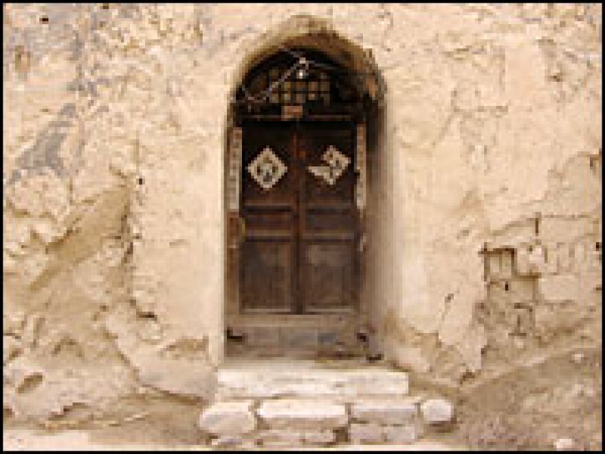 Many people on China's loess plateau live in caves dug into the hillsides. The cave dwellings are generally warm in the winter and cool in the summer. This is the door to Wei Zijian's cave home.