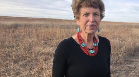 a woman stands in a field