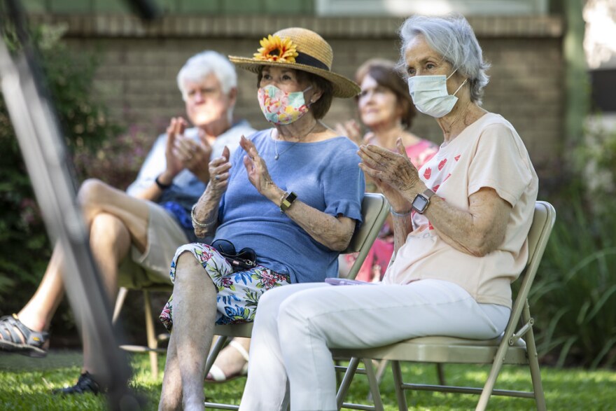 Neighbors listen to a free concert in the front yard of a Northwest Austin home on May 2.