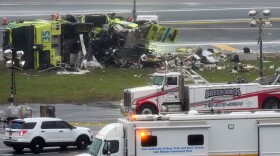 A Port Authority firetruck lays on its side just off the runway at LaGuardia Airport, Monday, March 23, 2026, after colliding with an Air Canada jet shortly after it landed late Sunday night in New York. (AP Photo/Seth Wenig)