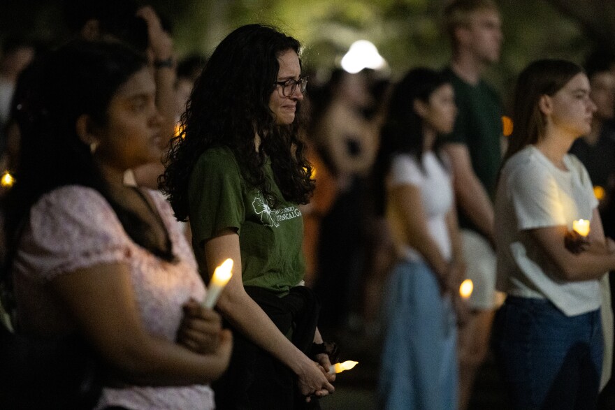 Lila Romero-Kibler, center, joins hundreds at a vigil for the Sixth Street shooting victims hosted by the University of Texas at Austin Student Government.
