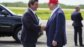 President Donald Trump is greeted by Gov. Ron DeSantis, R-Fla., as he arrives at "Alligator Alcatraz," a new migrant detention facility at Dade-Collier Training and Transition facility, Tuesday, July 1, 2025, in Ochopee, Fla.