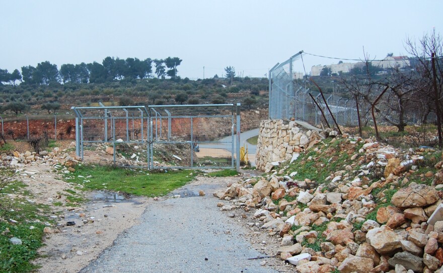 Israelis put up a small fence at the edge of the Palestinian village of Wadi Nis more than a decade ago to stop Palestinians from driving into the settlement of Efrat.