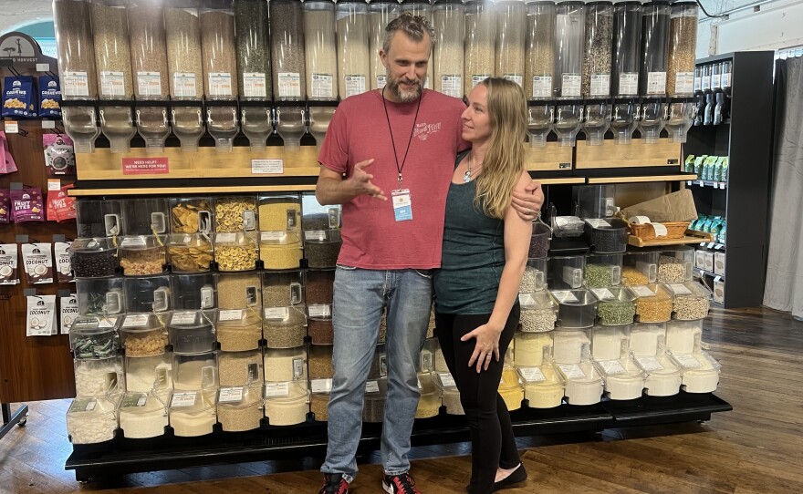 Co-owners Nathaniel Clifford [left] and Jade Jump [right] in front of their grains and spices sold in bulk at their new Holyoke location on Dwight Street.