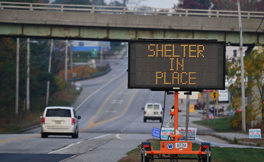 A shelter-in-place sign is displayed in Lewiston, Maine, on Friday.