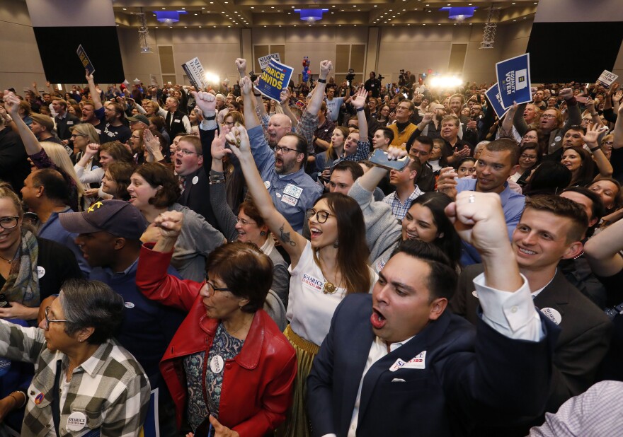 Supporters for Sharice Davids, a Democratic House candidate for Kansas, react as she is declared the winner during a watch party in Olathe, Kan., on Tuesday. Davids defeated incumbent Republican Rep. Kevin Yoder.