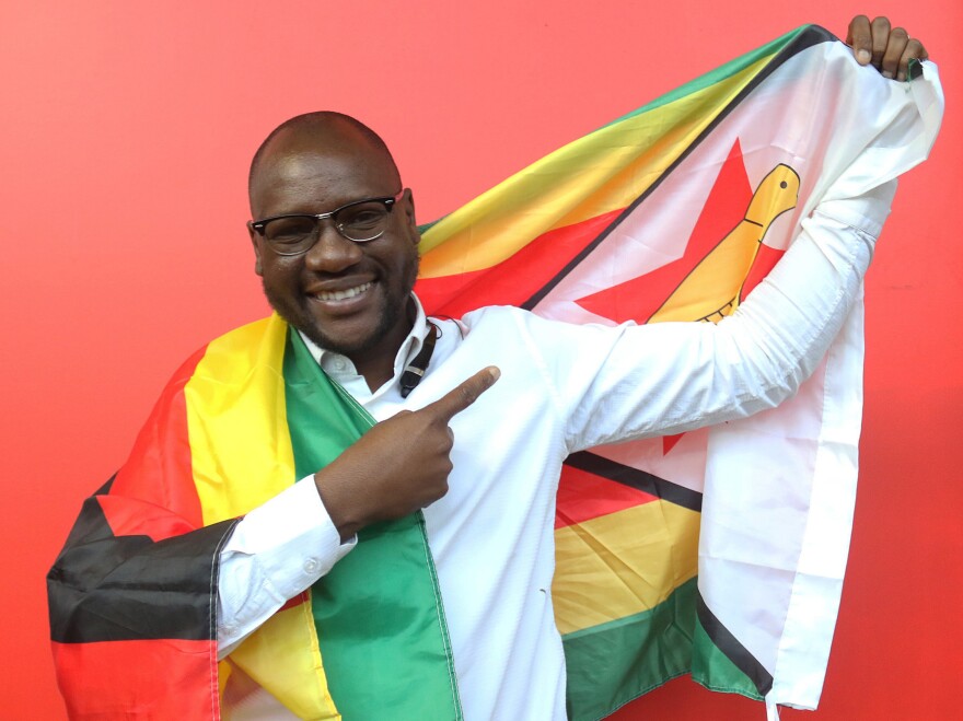 Evan Mawarire poses with a Zimbabwean flag in Harare, Zimbabwe, on May 3. He was arrested in July for inciting violence and disturbing the peace and left the country after he was released.