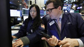 Specialist Vera Liu (left) and trader James Matthews work on the floor of the New York Stock Exchange on Wednesday. U.S. stocks are experiencing a post-Christmas rally after record-breaking losses on Monday.