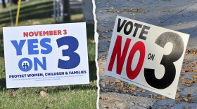 Two separate images, side by side. Each shows a yard sign. One on left reads "Yes on 3." The one on right reads "Vote No on 3."