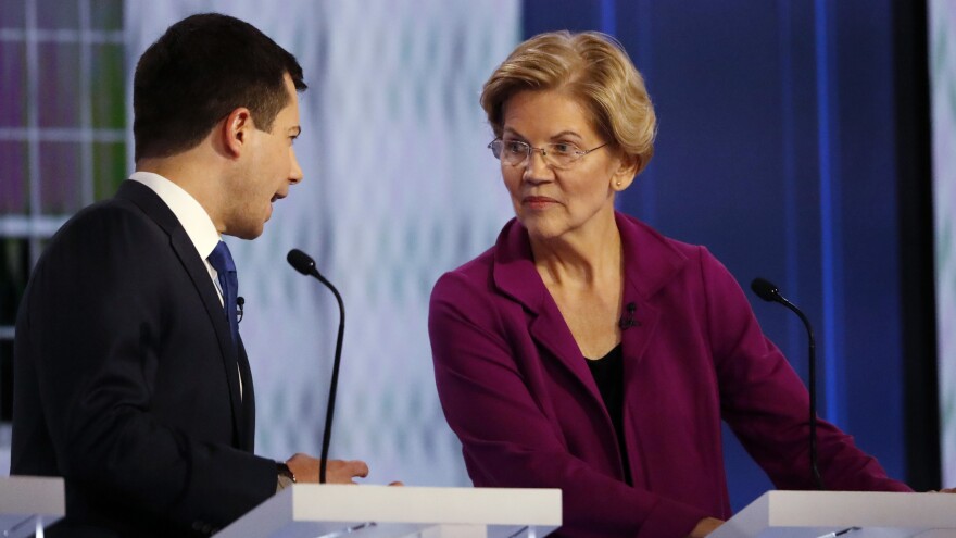 Democratic presidential candidate South Bend, Ind., Mayor Pete Buttigieg speaks with Sen. Elizabeth Warren, D-Mass., during a commercial break in the November Democratic presidential primary debate in Atlanta. They are back onstage Thursday in Los Angeles.
