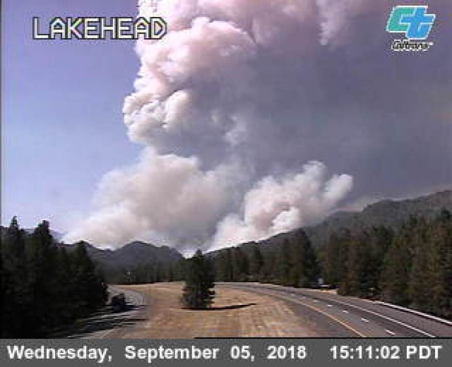 The CalTrans road cam at the Lakehead overcrossing shows a plume of smoke rising from the new Delta fire in Shasta County, California.