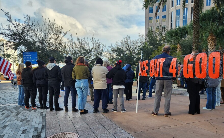 People gather at a vigil on Sunday, January 18, 2026, in front of Orlando City Hall, acknowledging the immigrant communities facing potential detention and deportation.
