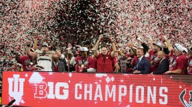 Indiana head coach Curt Cignetti holds the championship trophy after the Big Ten championship NCAA college football game against Ohio State in Indianapolis, Saturday, Dec. 6, 2025.