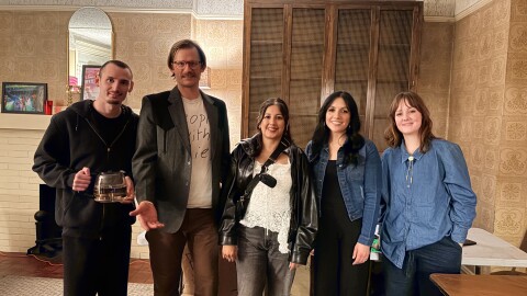 Five of the event organizers are standing together for a photo.