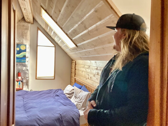  Aidan Proctor stands in front a room in the cabin he's renting with roommates in downtown Ketchum.