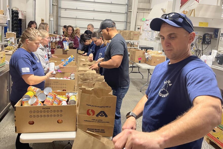 Alaska Air National Guard, volunteer at the Fairbanks Food Bank, packing food boxes in preparation for the Fairbanks Veterans Stand Down event. The VA Stand Down provides Veterans with medical care, information on local community services, food, and winter gear. The event brings Veterans and the community together to give back to Veterans while enjoying music, raffles, camaraderie, and receiving services. (U.S. Air National Guard photo by Senior Master Sgt. Julie Avey)