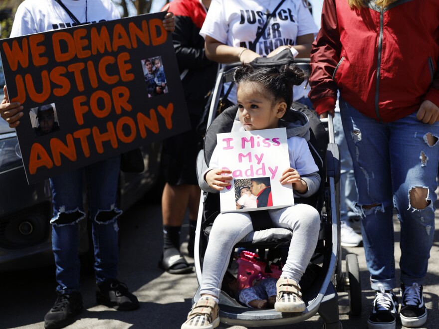 In this May 1, 2021, photo, Ailani Alvarez, 2, the daughter of Anthony Alvarez, who was shot by the police, holds a sign reading "I miss my daddy" during a protest in Chicago.