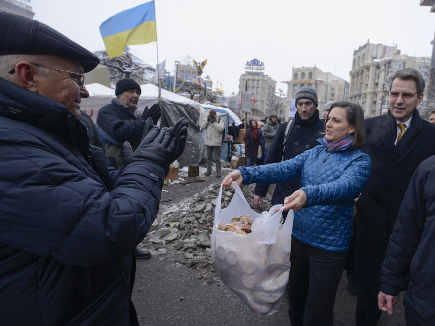 U.S. Assistant Secretary for European and Eurasian Affairs Victoria Nuland offered food to pro-European Union activists as she and U.S. Ambassador to Ukraine Geoffrey Pyatt, right, walked through Independence Square in Kiev, Ukraine, on Wednesday. She also offered food to some of the police nearby.