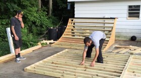 two men building skateboard ramp