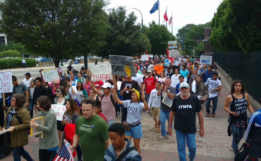 Immigrants and supporters on Trade Street near the Federal Reserve Monday afternoon during the "Day of Resistance."