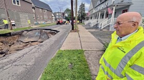 Wilkes-Barre Mayor George Brown stands near a sinkhole that opened Wednesday afternoon, June 25, on Horton Street in the city. Repairs could take several days, Brown said, and streets around the hole will be closed to all but residents in the meanwhile.