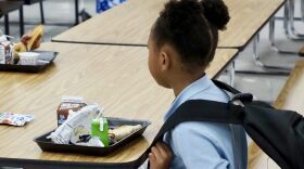 A student sits with a tray of food in the school cafeteria at Thelma R. Parks Elementary in Oklahoma City on Aug. 13, 2025. The Oklahoma State Department of Education recently discontinued a federal program that pays for third meals in schools with extended hours.