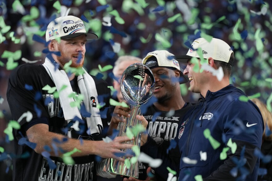Seattle Seahawks head coach Mike Macdonald and quarterback Sam Darnold, left, hold the Lombardi Trophy after a 29-13 win over the New England Patriots in the NFL Super Bowl 60 football game Sunday, Feb. 8, 2026, in Santa Clara, Calif. (AP Photo/Matt Slocum)